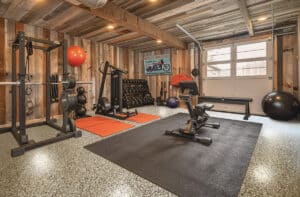 Clean basement featuring home gym area, neatly arranged exercise