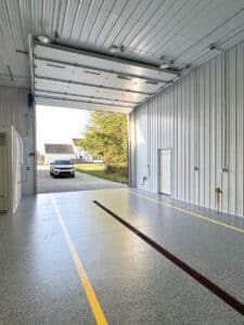 Car pulling into auto shop with OGI flooring