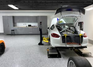 White car in garage with OGI flooring