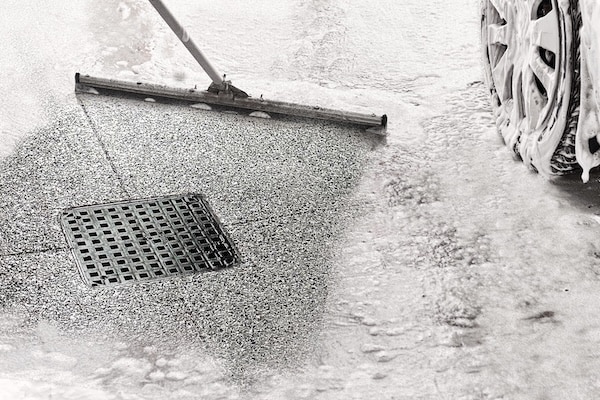 Man cleaning garage floor